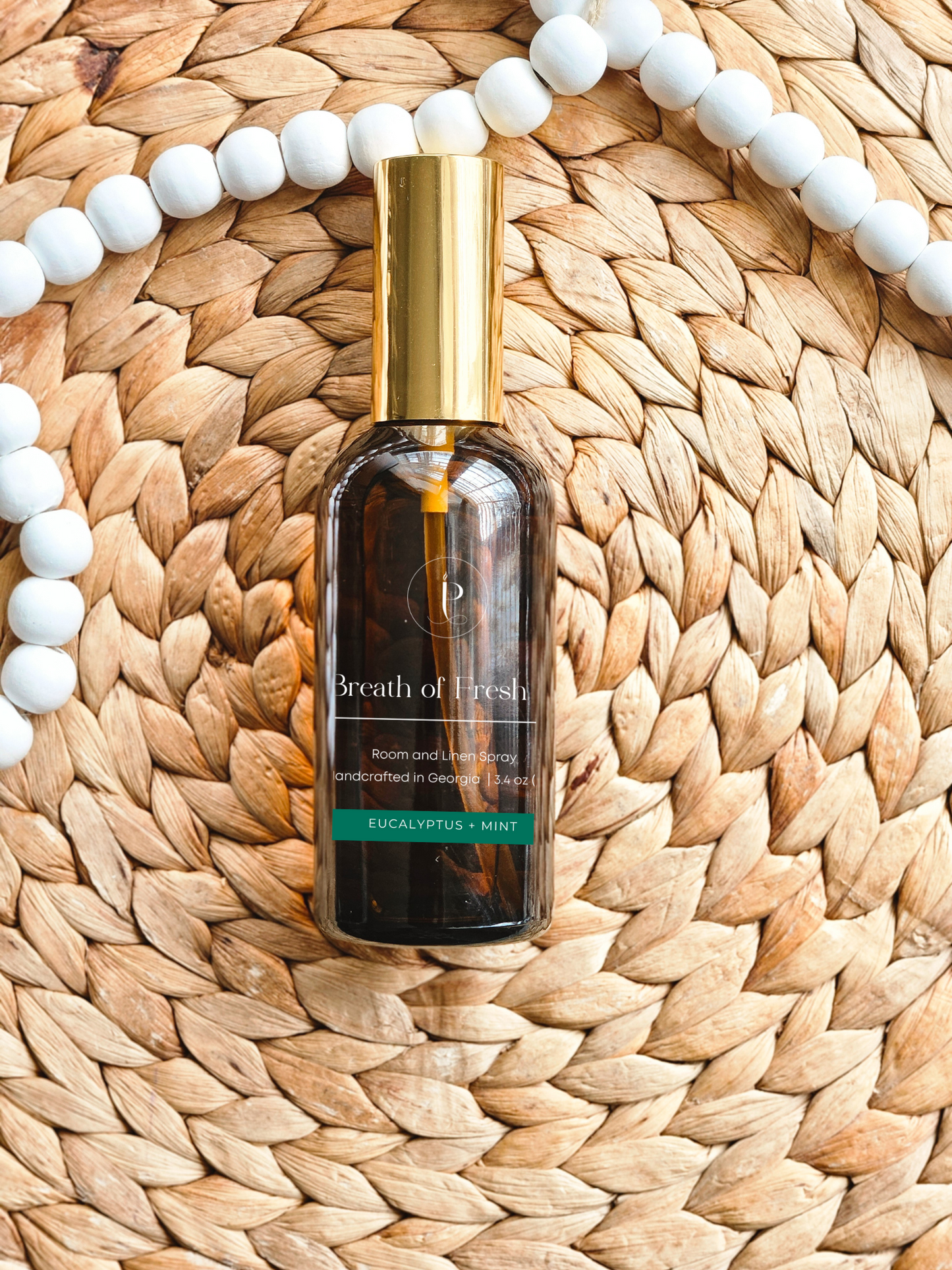 Hand misting bedding with Room & Linen Spray for mindful atmosphere