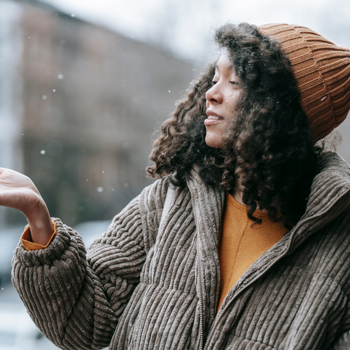 “You are the sky. Everything else—it's just the weather. Woman standing outside in the rain incorporating daily affirmations